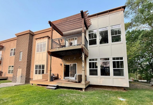 4132 Vernon Ave S Unit A101, Saint Louis Park, MN 55416 - back of house featuring a balcony, a lawn, and a wooden deck