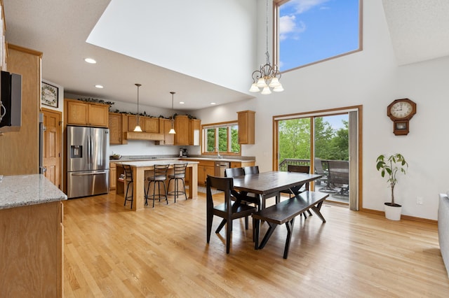 13910 47th Ln NE, Saint Michael, MN 55376 - dining area featuring recessed lighting, light wood-style flooring, baseboards, a high ceiling, and a chandelier