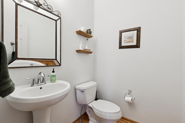13910 47th Ln NE, Saint Michael, MN 55376 - bathroom with toilet, wood finished floors, and baseboards