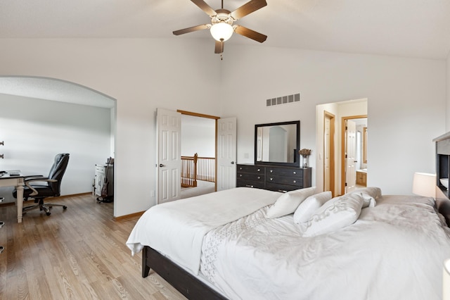13910 47th Ln NE, Saint Michael, MN 55376 - bedroom with high vaulted ceiling, light wood-style flooring, arched walkways, a desk, and baseboards