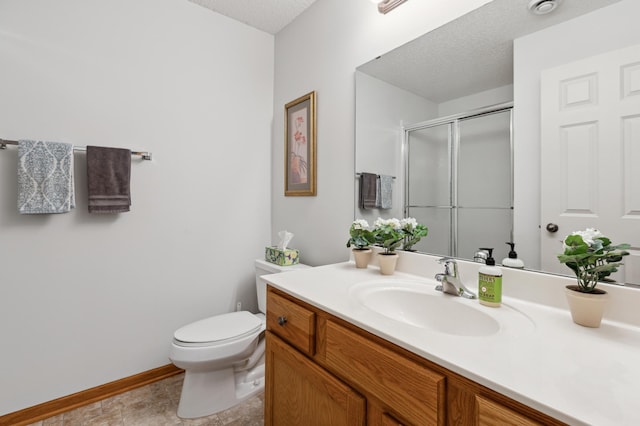 13910 47th Ln NE, Saint Michael, MN 55376 - full bath with vanity, a shower with shower door, toilet, a textured ceiling, and baseboards