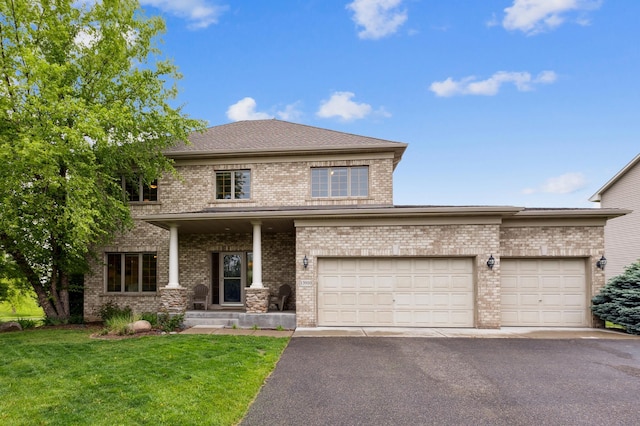13910 47th Ln NE, Saint Michael, MN 55376 - view of front of property featuring brick siding, a front yard, driveway, and a garage