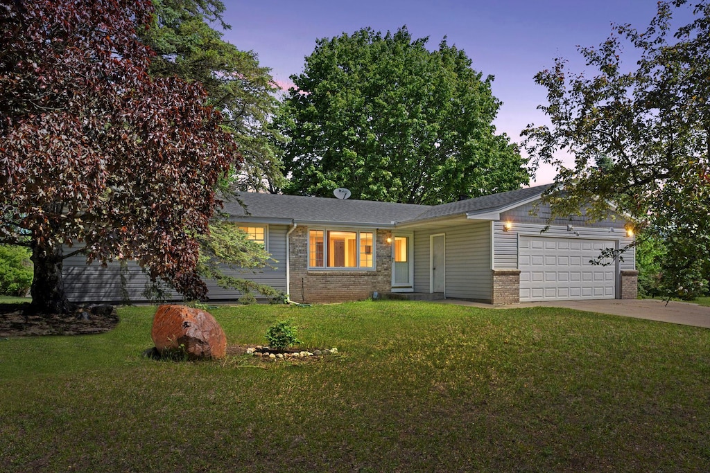 6747 158th Ln NW, Ramsey, MN 55303 - ranch-style home with brick siding, a garage, driveway, and a lawn