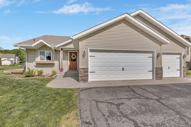 24405 18th Ave, Saint Augusta, MN 56301 - ranch-style home with driveway, a garage, stone siding, a front yard, and roof with shingles