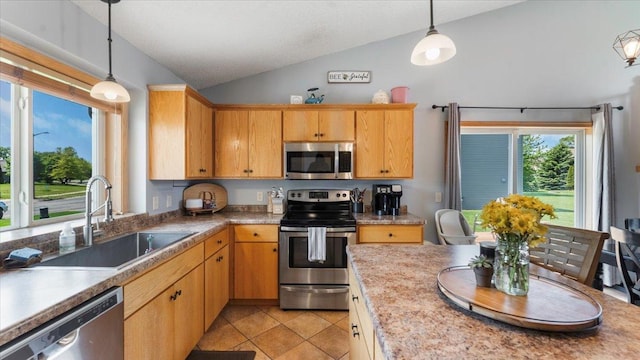 24405 18th Ave, Saint Augusta, MN 56301 - kitchen with appliances with stainless steel finishes, a sink, vaulted ceiling, light tile patterned floors, and hanging light fixtures