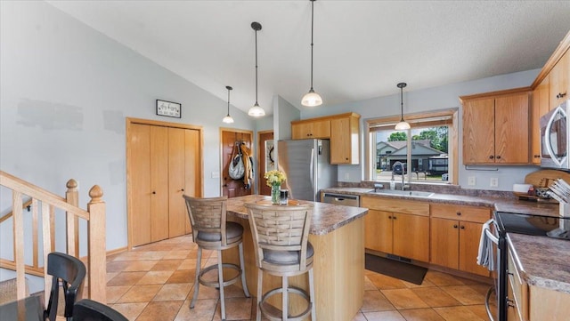 24405 18th Ave, Saint Augusta, MN 56301 - kitchen with a sink, appliances with stainless steel finishes, a kitchen island, decorative light fixtures, and dark countertops