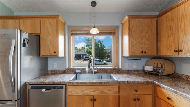 24405 18th Ave, Saint Augusta, MN 56301 - kitchen with stainless steel appliances, a sink, hanging light fixtures, and a textured ceiling