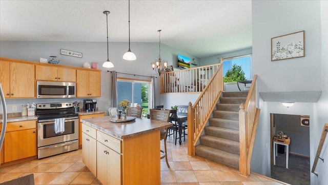 24405 18th Ave, Saint Augusta, MN 56301 - kitchen with appliances with stainless steel finishes, a kitchen island, a chandelier, plenty of natural light, and high vaulted ceiling