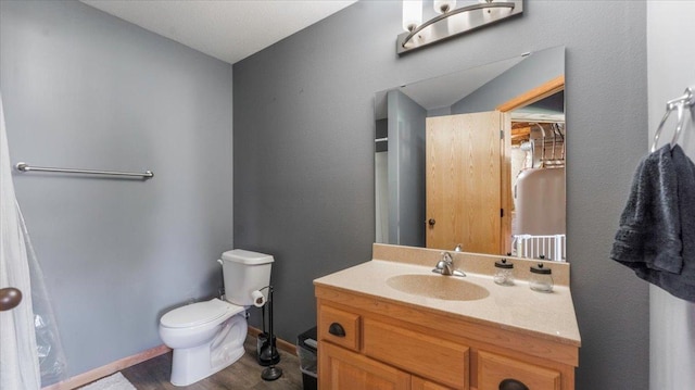 24405 18th Ave, Saint Augusta, MN 56301 - bathroom featuring toilet, vanity, wood finished floors, and baseboards