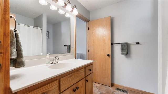 24405 18th Ave, Saint Augusta, MN 56301 - full bathroom featuring vanity, tile patterned floors, and baseboards