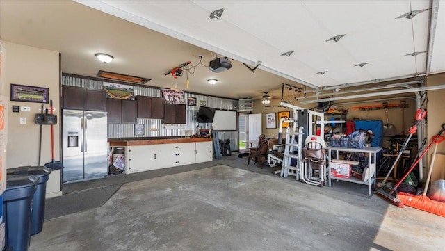 24405 18th Ave, Saint Augusta, MN 56301 - garage featuring stainless steel fridge and a garage door opener