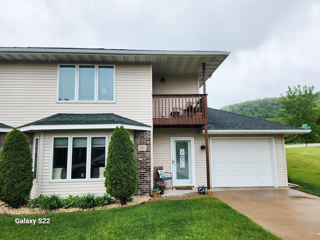 101 Janet Marie Ln, Winona, MN 55987 - traditional-style home with a balcony, a front yard, concrete driveway, an attached garage, and roof with shingles