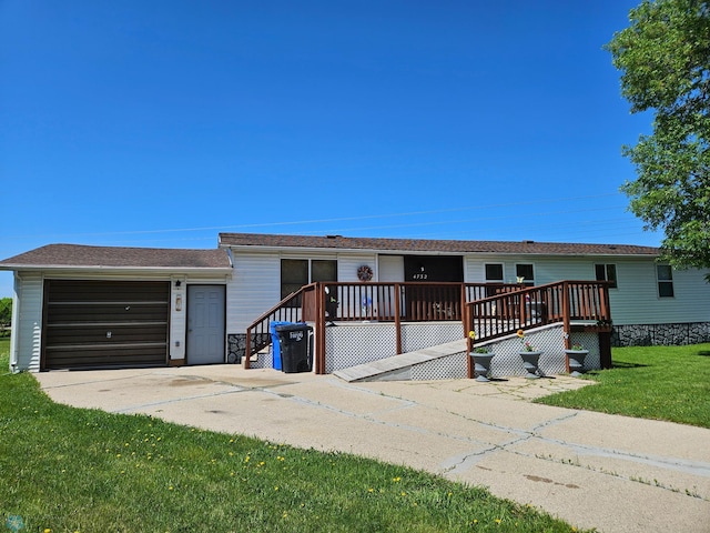 4732 San Juan Dr, Fargo, ND 58103 - view of front of house featuring a garage, a front yard, and a deck