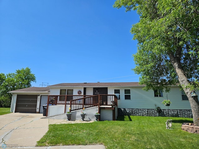 4732 San Juan Dr, Fargo, ND 58103 - manufactured / mobile home featuring concrete driveway, a deck, a front yard, and a garage
