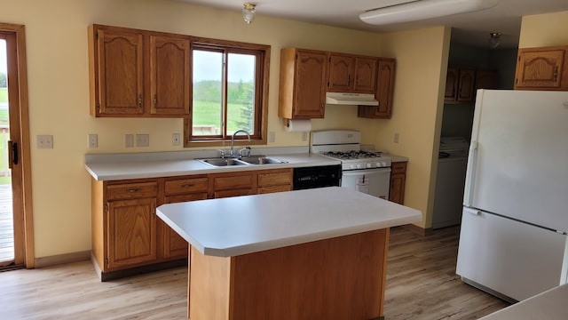 3454 44th Ave SW, Pine River, MN 56474 - kitchen with white appliances, under cabinet range hood, a sink, and light wood-style floors