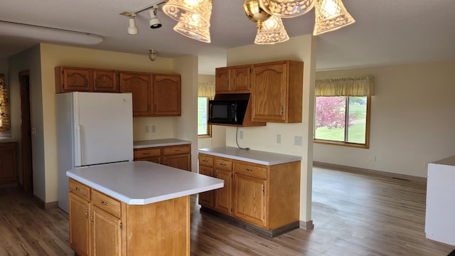 3454 44th Ave SW, Pine River, MN 56474 - kitchen with black microwave, light wood finished floors, light countertops, and freestanding refrigerator