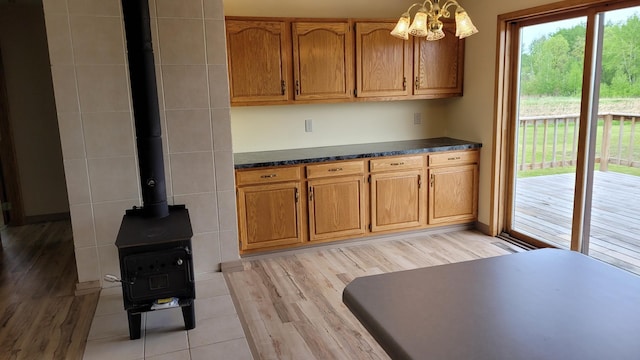 3454 44th Ave SW, Pine River, MN 56474 - kitchen featuring dark countertops, light wood-style floors, and brown cabinetry