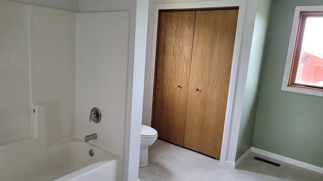 3454 44th Ave SW, Pine River, MN 56474 - bathroom featuring toilet, washtub / shower combination, tile patterned flooring, a closet, and baseboards
