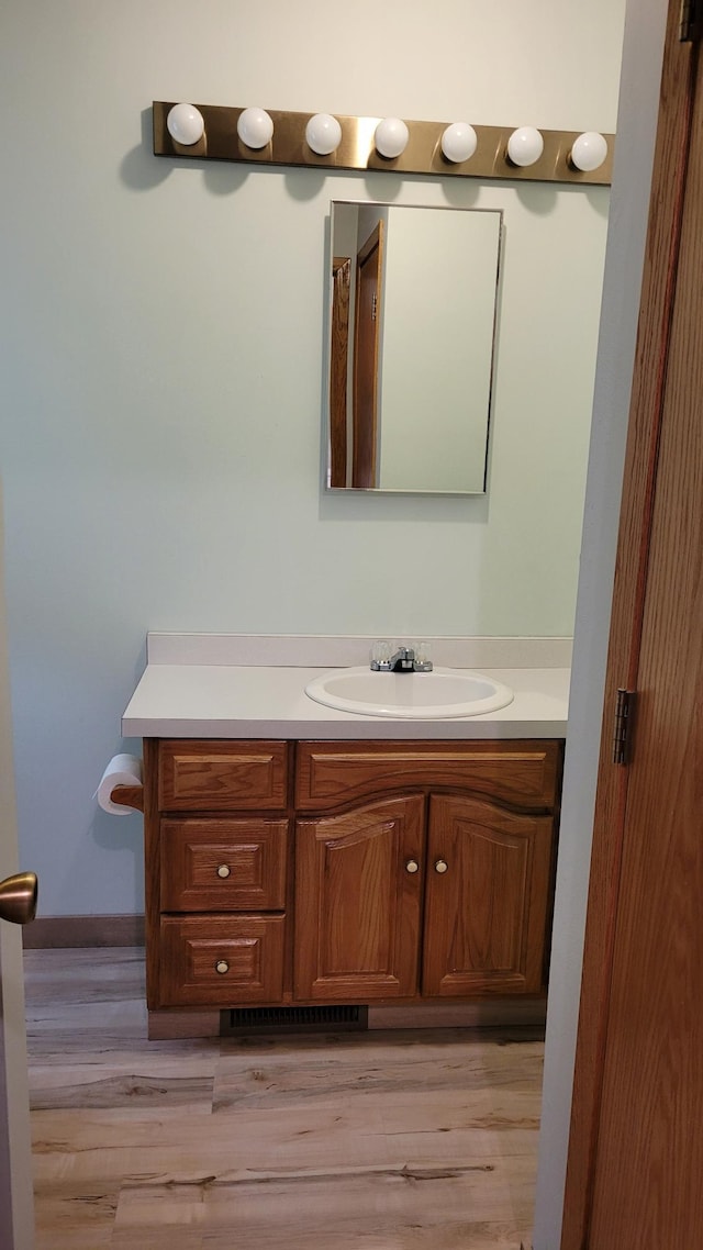 3454 44th Ave SW, Pine River, MN 56474 - bathroom featuring vanity, wood finished floors, and baseboards
