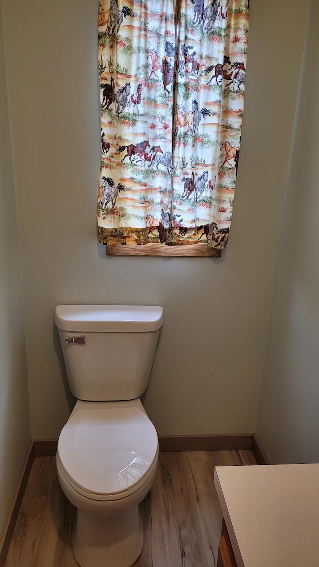 3454 44th Ave SW, Pine River, MN 56474 - half bath featuring toilet, baseboards, and wood finished floors