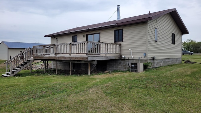3454 44th Ave SW, Pine River, MN 56474 - back of property with a lawn, a deck, stairway, and central air condition unit