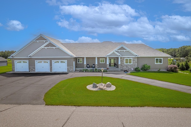 2142 Monarch Ct, Sartell, MN 56377 - view of front of house with stone siding, driveway, a front lawn, and an attached garage