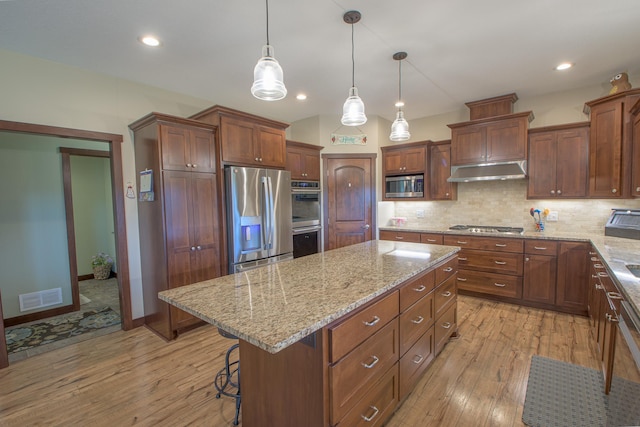 2142 Monarch Ct, Sartell, MN 56377 - kitchen featuring appliances with stainless steel finishes, a kitchen island, light wood-style flooring, tasteful backsplash, and recessed lighting