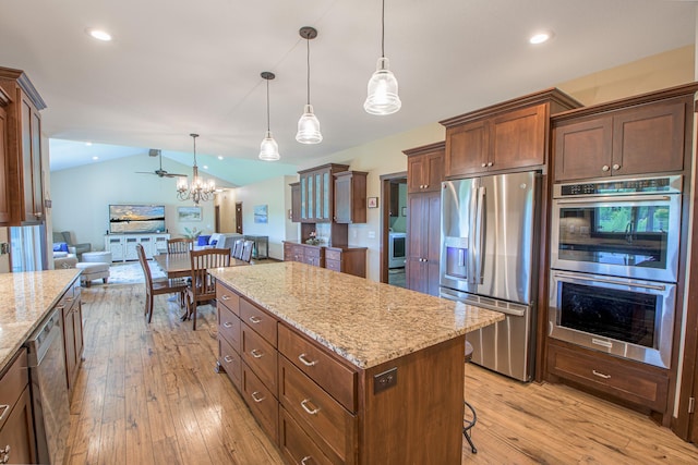 2142 Monarch Ct, Sartell, MN 56377 - kitchen featuring appliances with stainless steel finishes, lofted ceiling, open floor plan, light wood-type flooring, and a center island