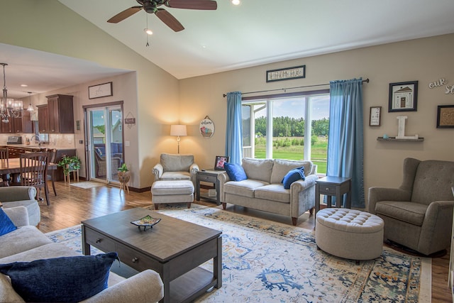 2142 Monarch Ct, Sartell, MN 56377 - living room featuring light wood finished floors, ceiling fan, a chandelier, high vaulted ceiling, and recessed lighting