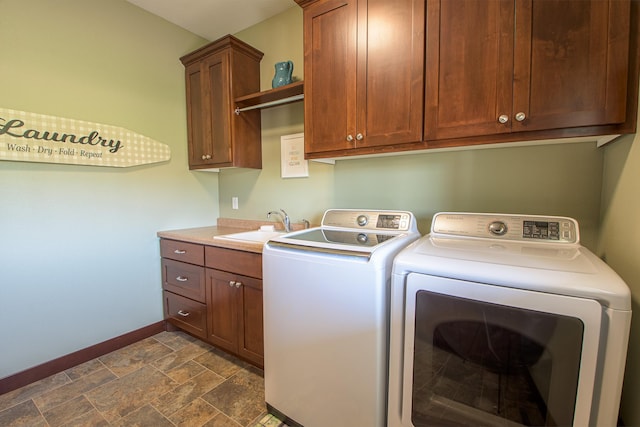 2142 Monarch Ct, Sartell, MN 56377 - washroom with baseboards, cabinet space, washing machine and dryer, and dark stone finish flooring