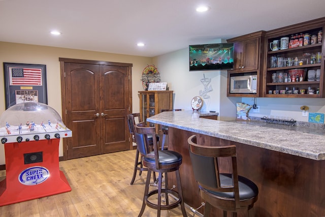 2142 Monarch Ct, Sartell, MN 56377 - indoor bar featuring built in microwave, light wood-style flooring, and recessed lighting