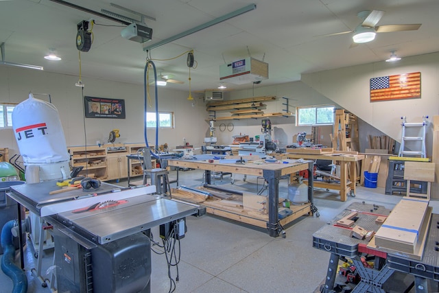 2142 Monarch Ct, Sartell, MN 56377 - garage with a workshop area, a garage door opener, a ceiling fan, and a heating unit