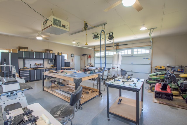 2142 Monarch Ct, Sartell, MN 56377 - garage featuring a ceiling fan, a heating unit, and a workshop area
