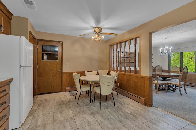 2916 Golf View Ct, Saint Cloud, MN 56301 - dining space with a baseboard heating unit, a wainscoted wall, a ceiling fan, and a chandelier