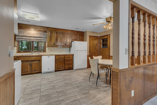 2916 Golf View Ct, Saint Cloud, MN 56301 - kitchen featuring white appliances, a ceiling fan, a sink, brown cabinetry, and decorative backsplash