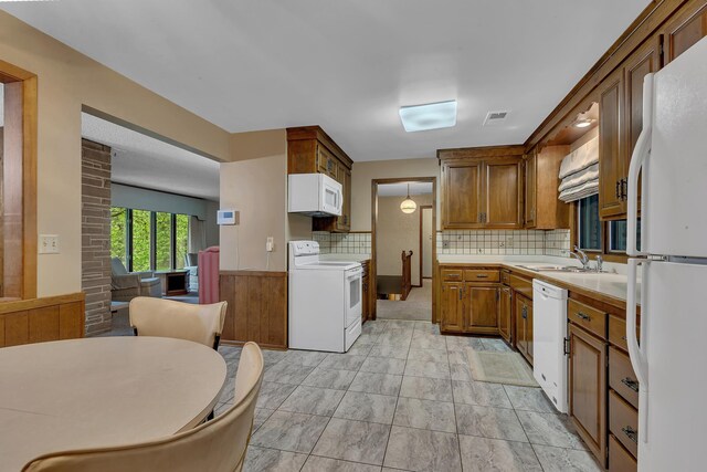 2916 Golf View Ct, Saint Cloud, MN 56301 - kitchen with white appliances, a sink, light countertops, and decorative backsplash