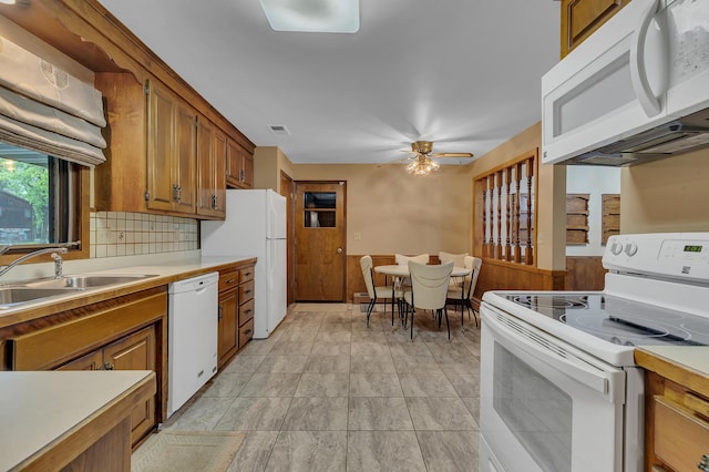 2916 Golf View Ct, Saint Cloud, MN 56301 - kitchen with white appliances, a sink, brown cabinetry, and light countertops