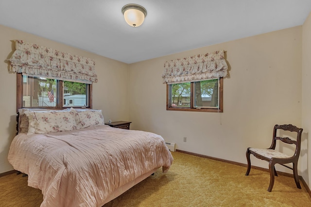 2916 Golf View Ct, Saint Cloud, MN 56301 - bedroom with multiple windows, baseboard heating, baseboards, and light colored carpet