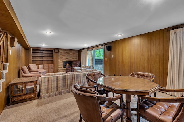 2916 Golf View Ct, Saint Cloud, MN 56301 - carpeted dining area with wooden walls, a fireplace, and built in shelves