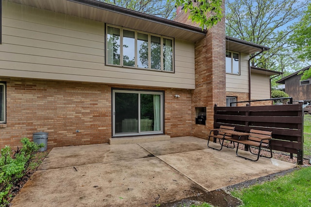 2916 Golf View Ct, Saint Cloud, MN 56301 - rear view of property with brick siding, a chimney, and a patio area