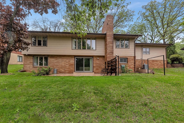 2916 Golf View Ct, Saint Cloud, MN 56301 - rear view of house featuring brick siding, a lawn, a chimney, and a patio