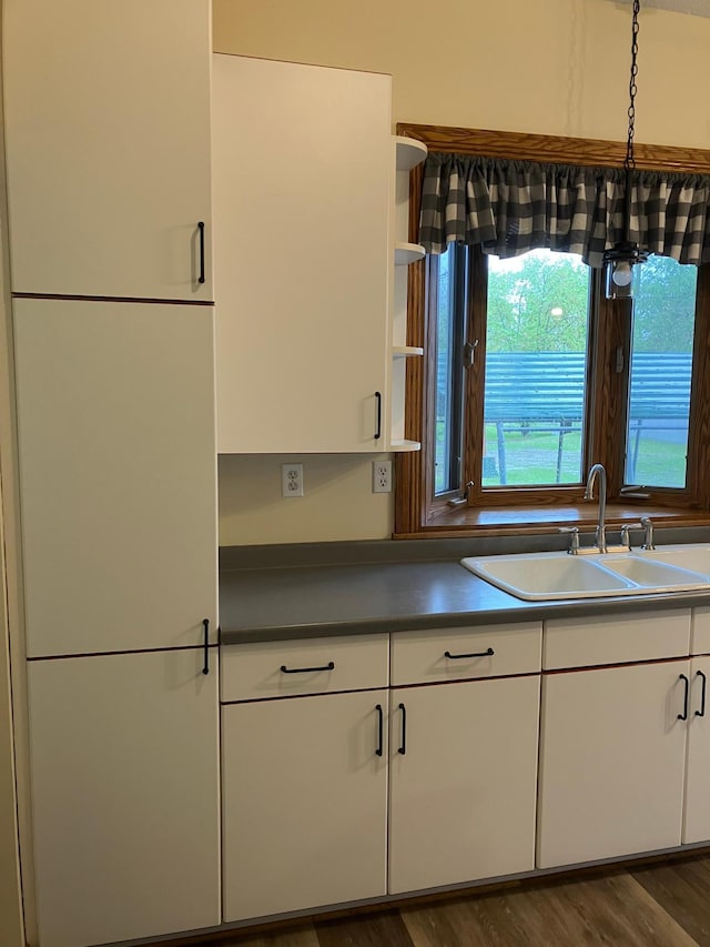 903 2nd St, Princeton, MN 55371 - kitchen with a sink, white cabinetry, open shelves, dark wood finished floors, and dark countertops