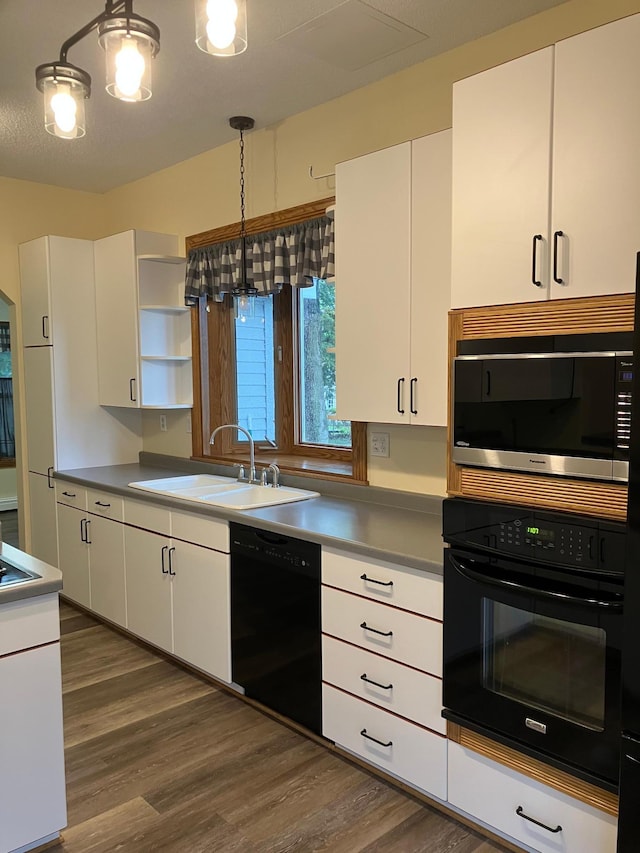 903 2nd St, Princeton, MN 55371 - kitchen with black appliances, a sink, open shelves, and white cabinets