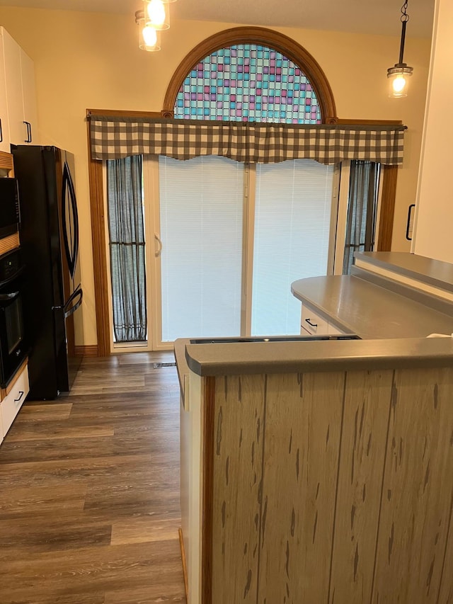 903 2nd St, Princeton, MN 55371 - kitchen with black appliances, dark wood-style flooring, white cabinetry, and stainless steel counters