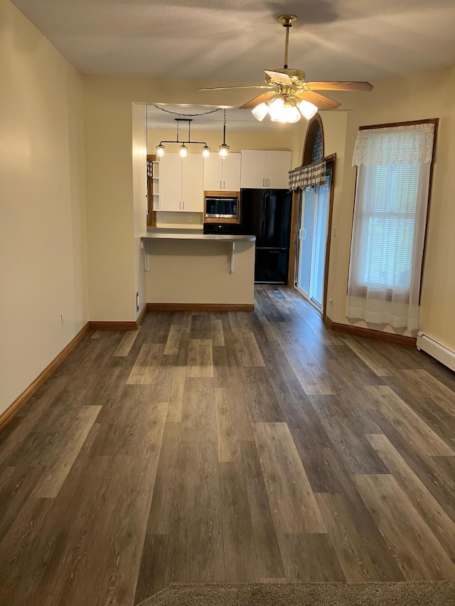 903 2nd St, Princeton, MN 55371 - kitchen featuring freestanding refrigerator, built in microwave, a peninsula, white cabinets, and ceiling fan