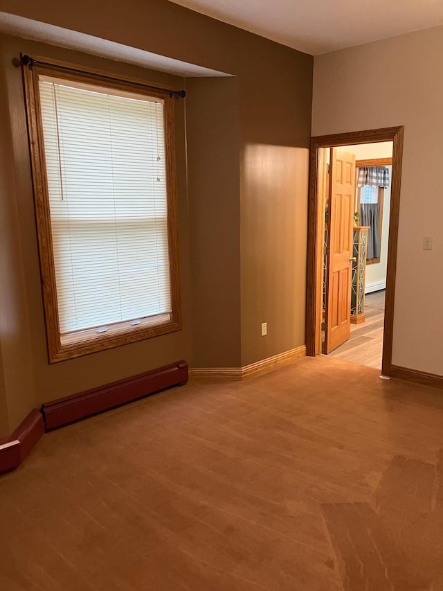 903 2nd St, Princeton, MN 55371 - empty room featuring baseboard heating, baseboards, and light wood-type flooring