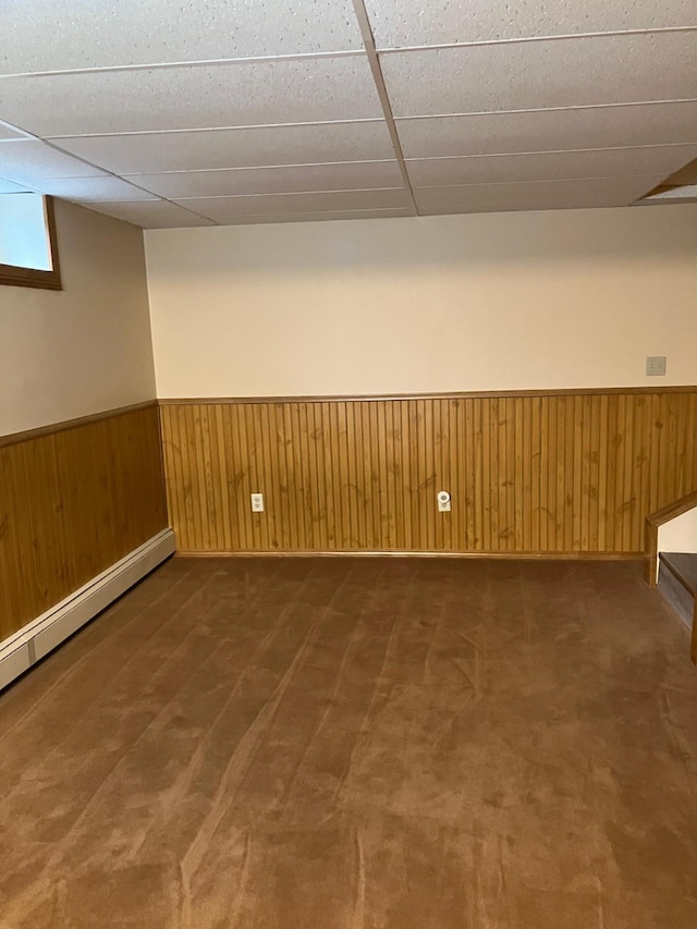 903 2nd St, Princeton, MN 55371 - basement with a wainscoted wall, carpet flooring, and baseboard heating
