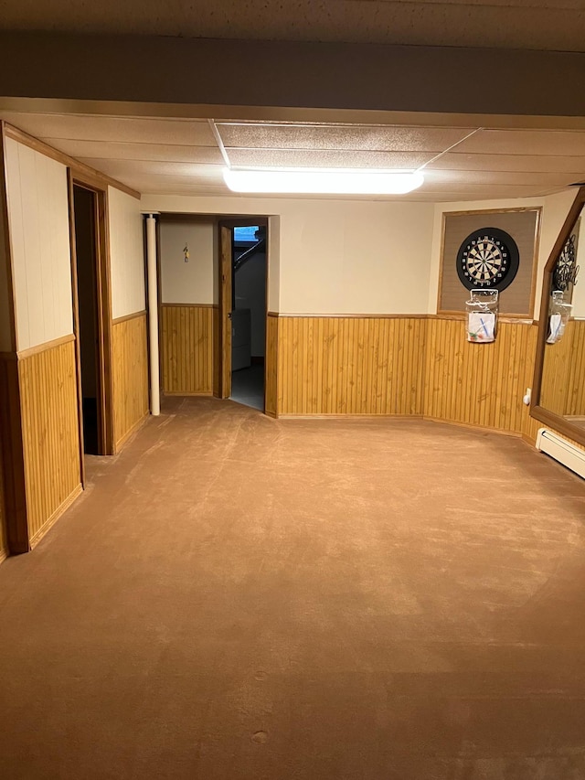 903 2nd St, Princeton, MN 55371 - finished basement featuring a wainscoted wall, carpet floors, wood walls, and baseboard heating