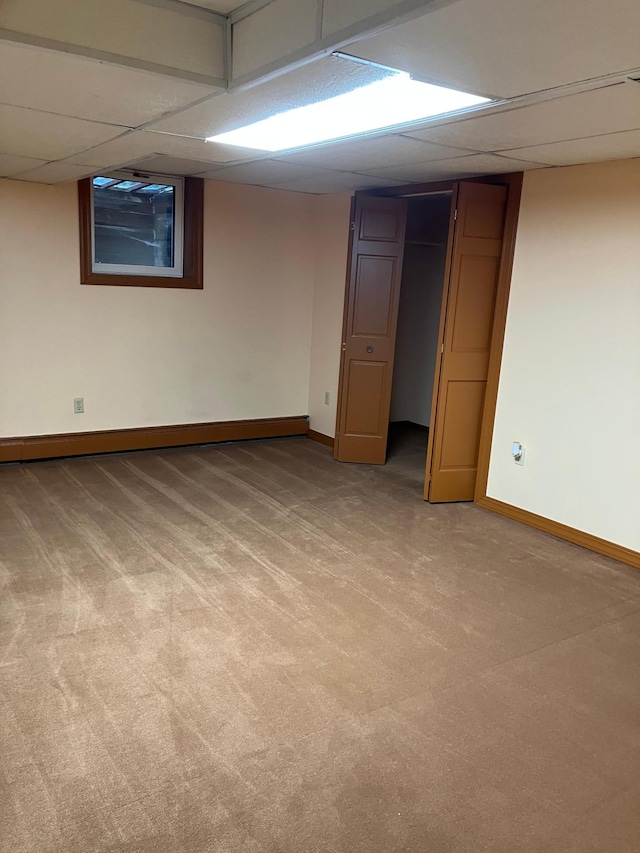 903 2nd St, Princeton, MN 55371 - finished basement featuring a paneled ceiling, light colored carpet, and baseboards