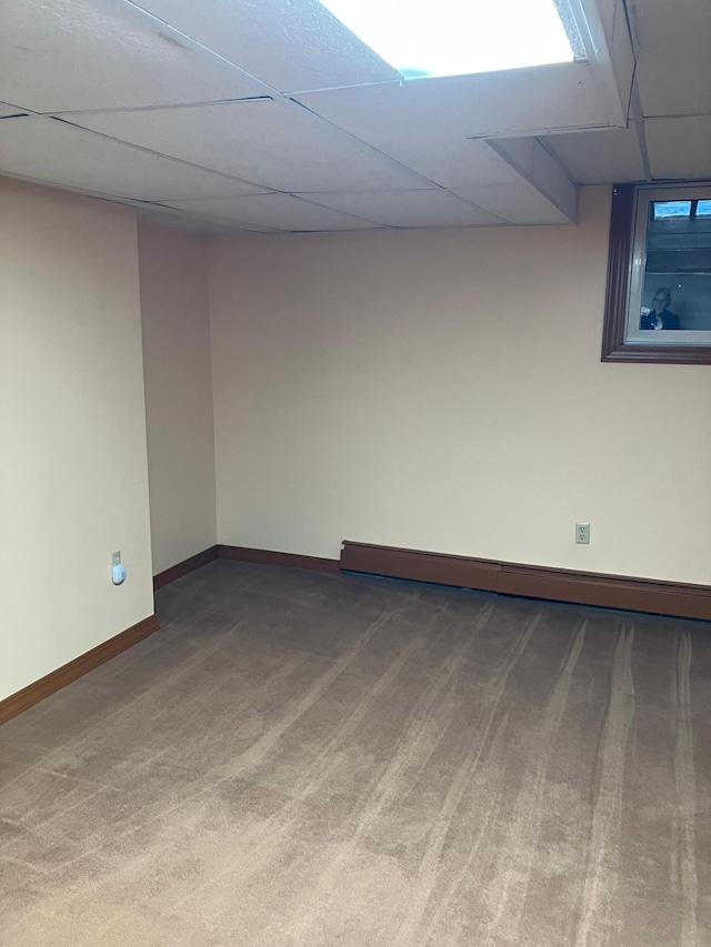 903 2nd St, Princeton, MN 55371 - carpeted empty room featuring a paneled ceiling, baseboards, and baseboard heating